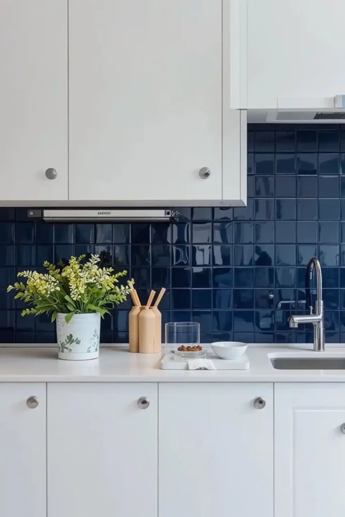 Navy glossy tile backsplash with white cabinets